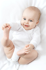 Portrait of happy baby on the bed