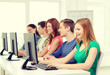 © Syda Productions - female student with classmates in computer class