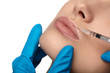 Woman receiving cosmetic injection in lip