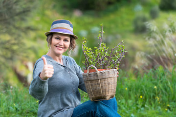 Woman with thumbs up gesture in nature