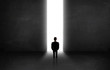 © ra2 studio - Business person looking at wall with light tunnel opening