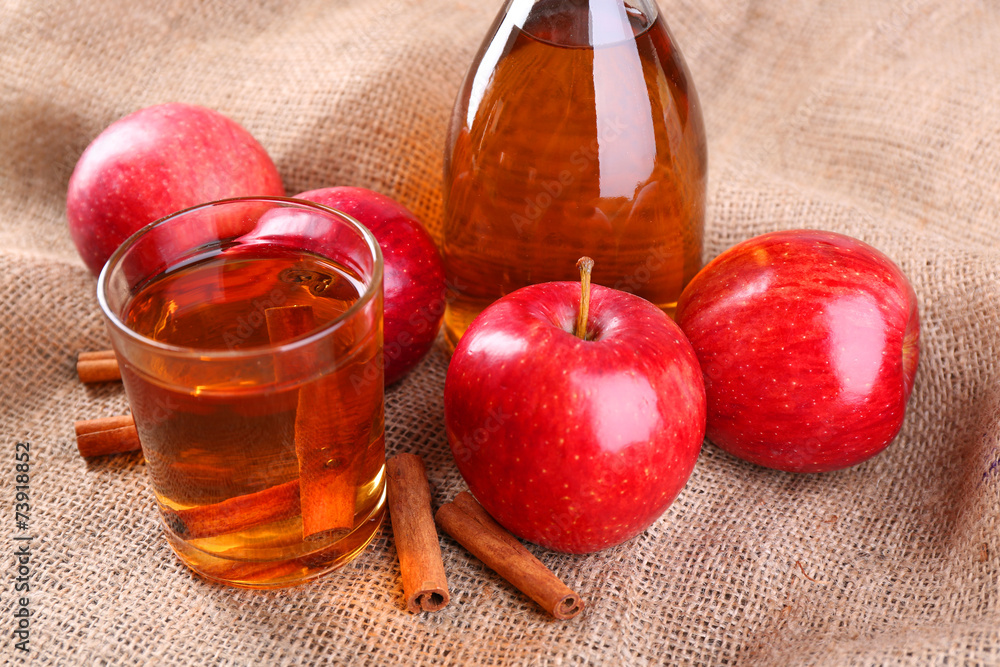 Apple cider with cinnamon sticks and fresh apples
