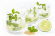 Three glasses with Mojito cocktail on a white background