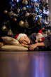 © Denizo - A boy sleeps under the Christmas tree