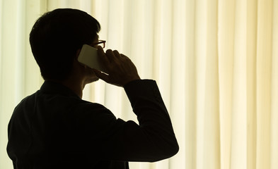 silhouette of businessman with mobile phone