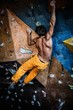Man practicing rock-climbing on a rock wall indoors