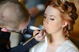 Fototapeta Do pokoju - Young beautiful bride applying wedding make-up