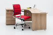 wood desk and red armchair