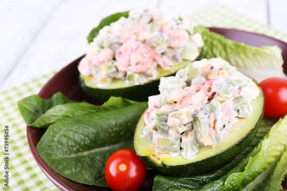 Tasty salad in avocado on plate table close-up
