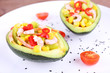 Tasty salad in avocado on plate close-up