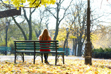 Lonely Woman On Bench In Park