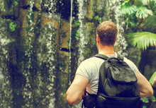 Tourist With Backpack Near Waterfall. Vintage Effect. Space For