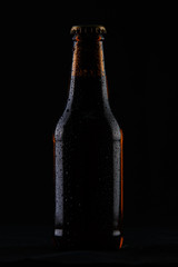 cold bottle of beer on black background