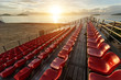 © SKT Studio - Empty plastic chairs at temporary grandstand stadium in Phuket,