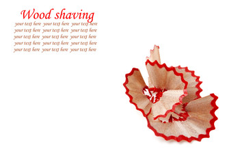 Red pencil and wood shavings isolated on white background