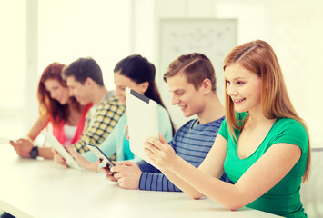 Wall Mural - smiling students with tablet pc at school