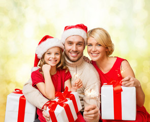 Poster - smiling family holding gift boxes and sparkles