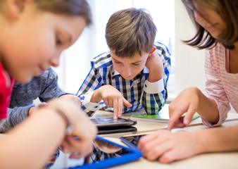 Canvas Print - group of school kids with tablet pc in classroom