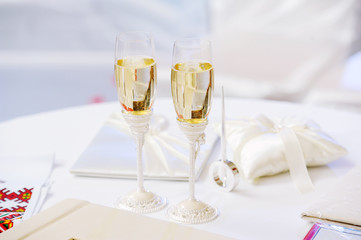 two glasses with champagne standing on the table