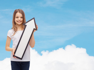 Wall Mural - smiling little girl with blank arrow pointing up