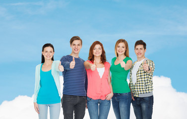 Wall Mural - group of smiling students showing thumbs up
