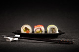 Fototapeta Londyn - Luxurious sushi on black background - japanese cuisine