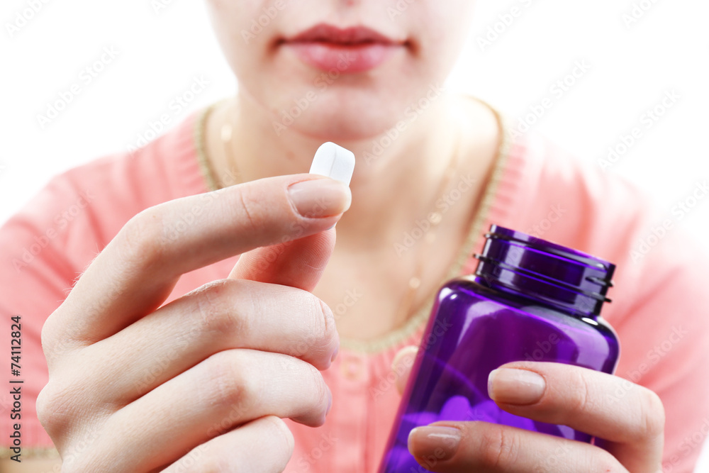 Pill in hand, close-up