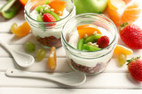 Fototapeta Kuchnia - Healthy dessert with muesli and fruits on table