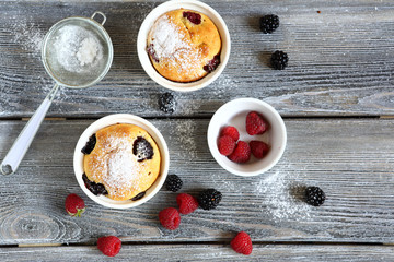 Wall Mural - Two cupcakes with sweet berries