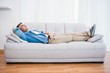 © WavebreakmediaMicro - Smiling man lying and relaxing on the couch