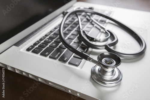 Fotografie, Obraz Medical Stethoscope Resting on Laptop Computer