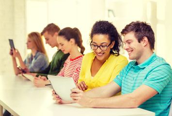 Sticker - smiling students looking at tablet pc at school