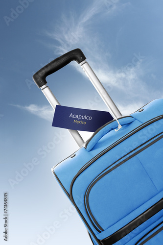 Fotografija Acapulco, Mexico. Blue suitcase with label