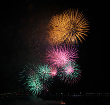 Close-up Of Yellow, Pink And Green Fireworks Display