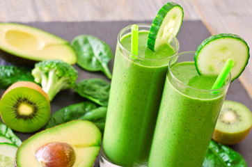 Wall Mural - Green smoothie in glasses with avocado, kiwi and spinach