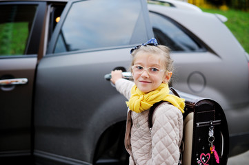 School aged kid girl near the car