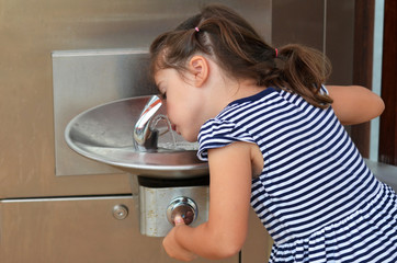 Child Drinking From Outdoor Water Fountain