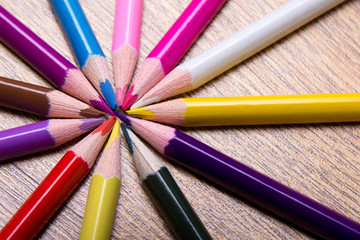 colored drawing pencils on wooden table