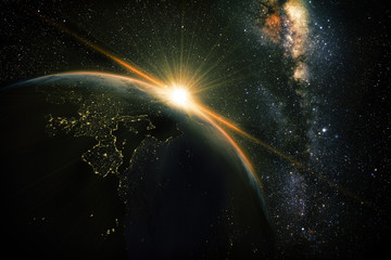 Wall Mural - unrise view of earth from space with milky way galaxy