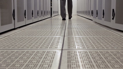 Poster - Data technician walking through locker hall