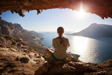 Young woman enjoying beautiful view at sunset