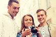 © Syda Productions - group of smiling friends with digital photocamera