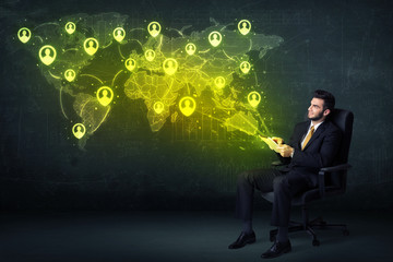 Wall Mural - Businessman in office with tablet and social network world map