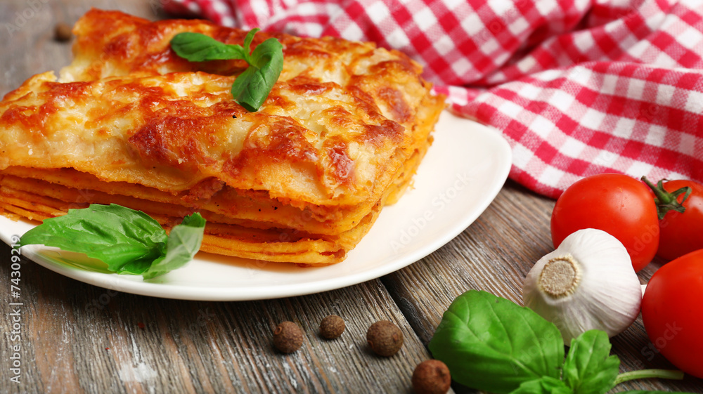 Portion of tasty lasagna on wooden table