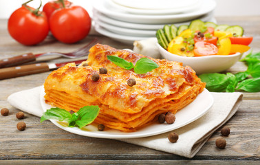 Canvas Print - Portion of tasty lasagna on wooden table