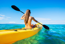 Woman Kayaking In The Ocean On Vacation