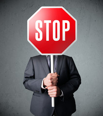 Businessman holding a stop sign