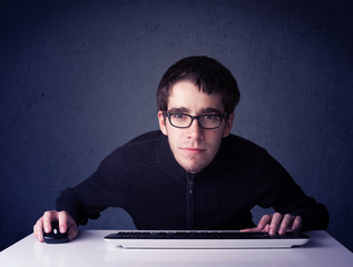 Fototapete - Hacker working with keyboard on blue background