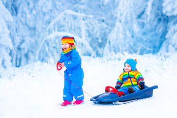 Wall Mural - Little children enjoying a sleigh ride