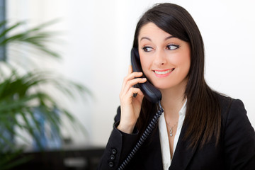 Smiling businesswoman at the phone